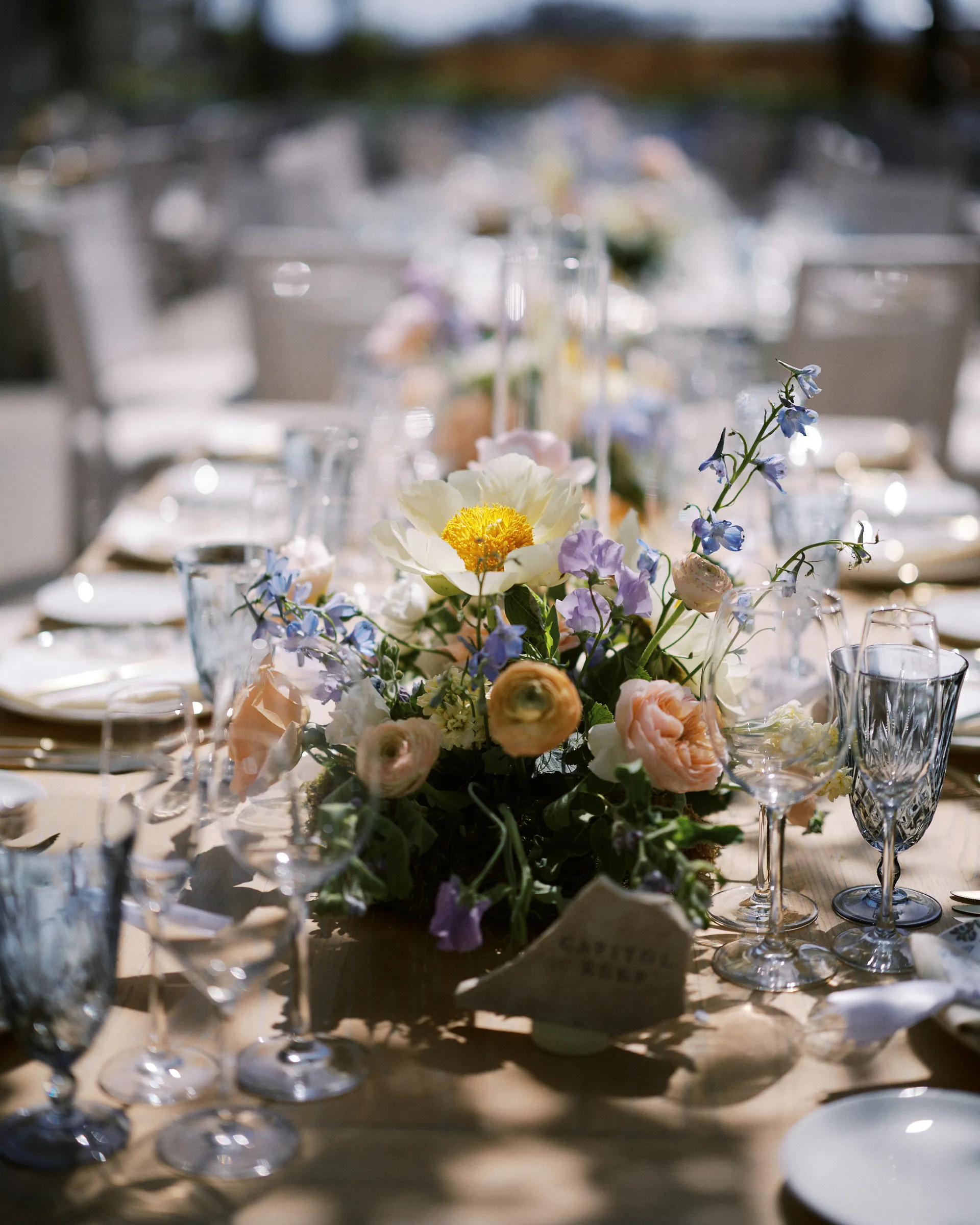 A reception table set with florals and glassware