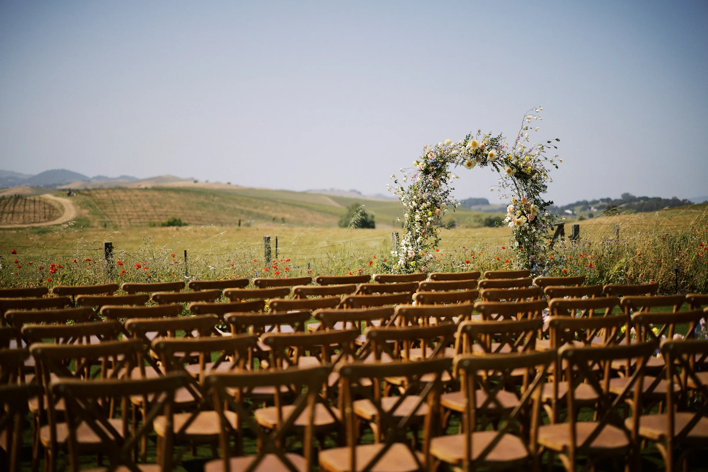 The ceremony arch standing in a golden Napa field