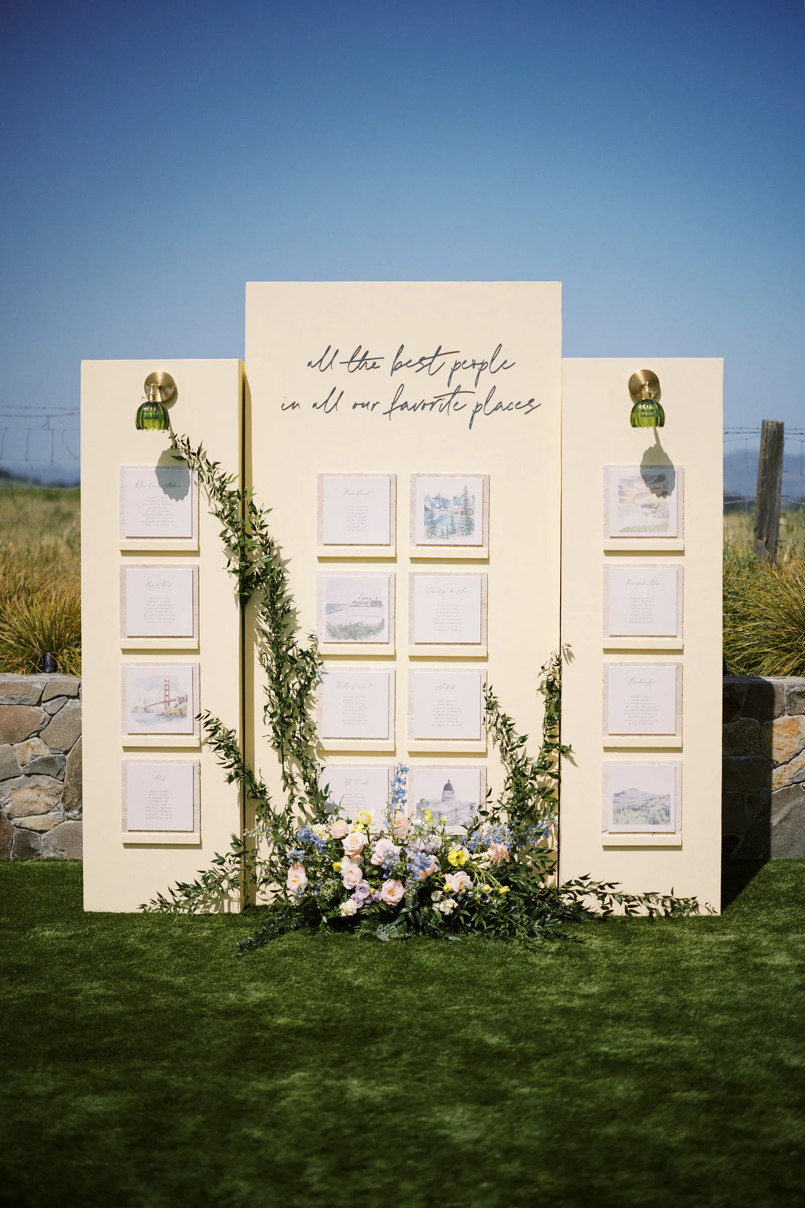 The seating chart display wreathed in greenery and flowers