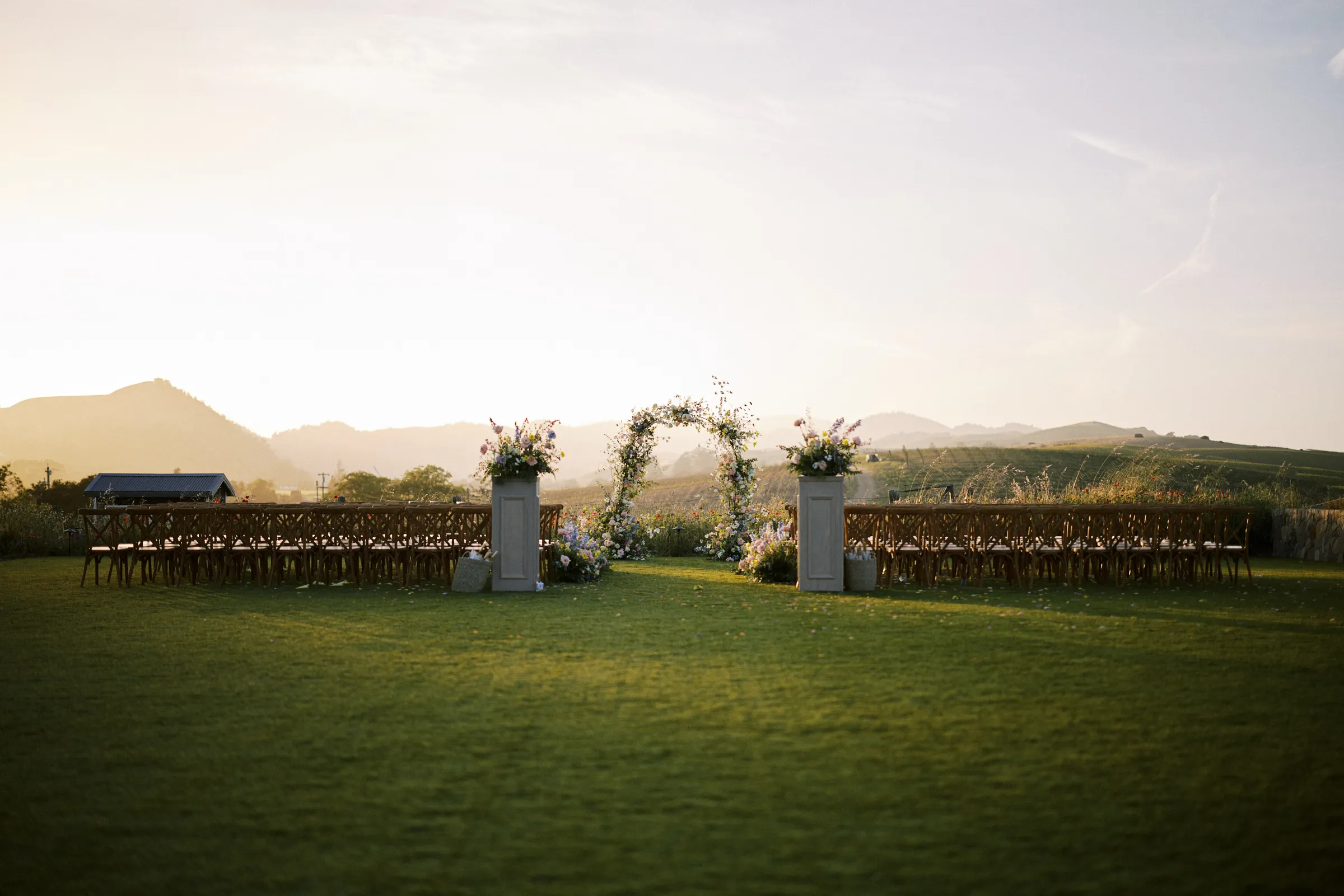 The empty ceremony site at sunset, mountains beyond